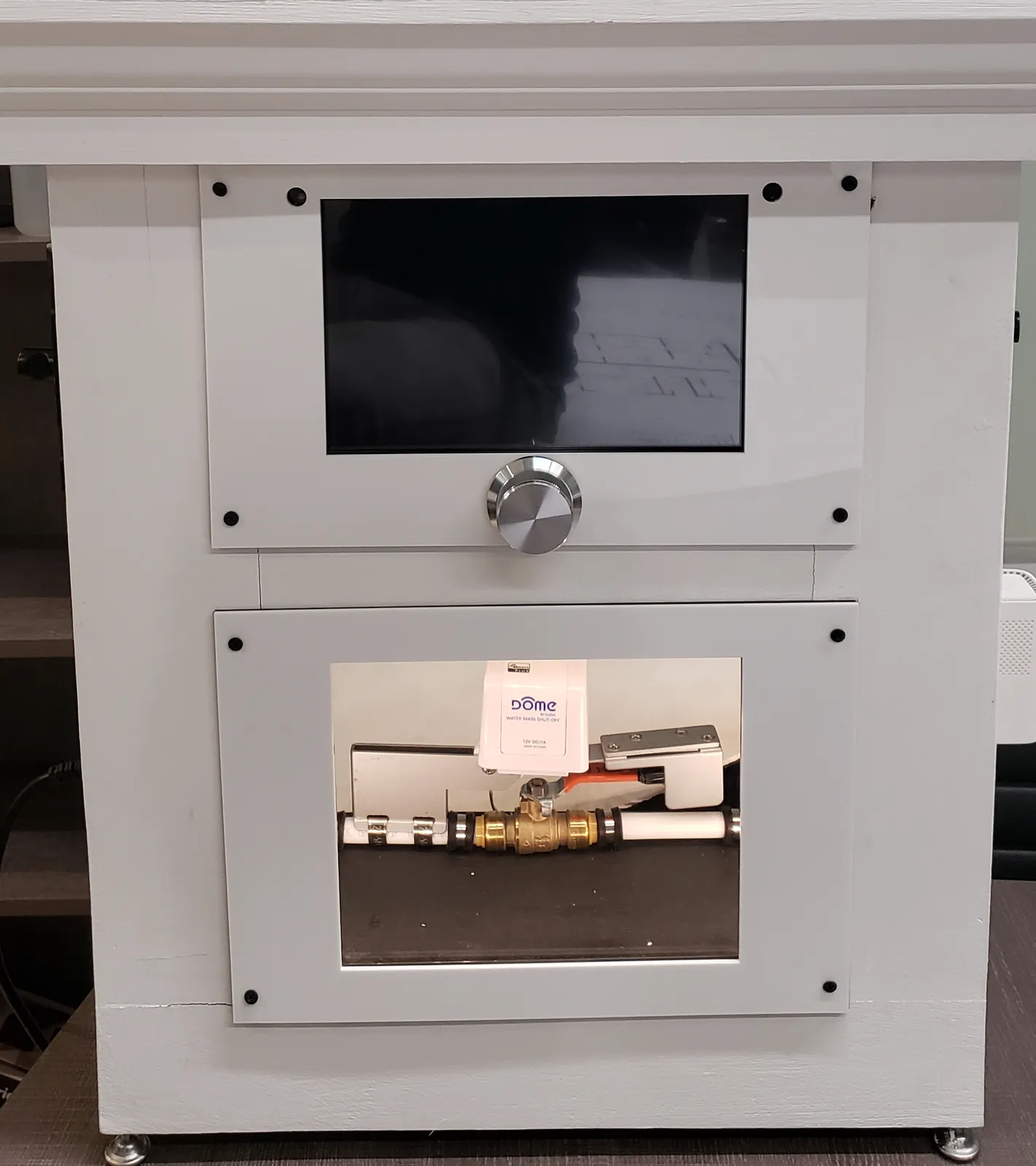 Concierge prototype: a touchscreen with a rotary jog wheel above a viewing window onto a motorized water-main shut-off valve.